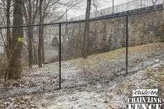 6 Foot High System21 Black Chain-Link Fence Following Grade